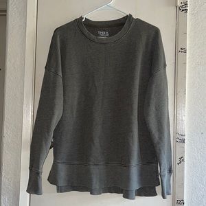 Green sweater with cut sides